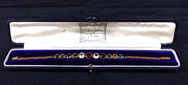 A GILT METAL AND COLOURED PASTE BRACELET