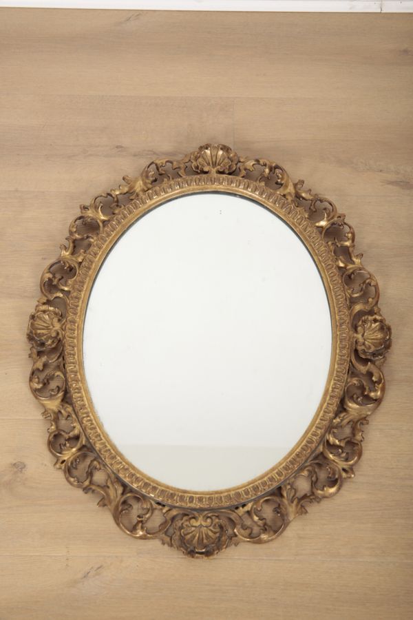 A CARVED GILTWOOD MIRROR