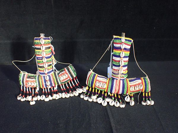 A PAIR OF AFRICAN COWRIE SHELL AND BEADWORK  ANCHOR SHAPED FLASKS