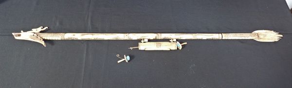 A BONE DART FIRING PIPE, WITH DRAGON HEAD