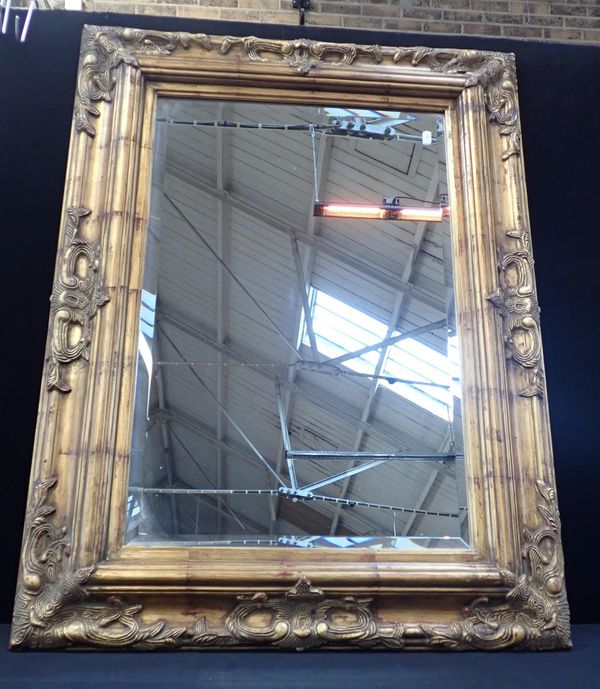 A MOULDED AND GILT  FRAMED WALL MIRROR