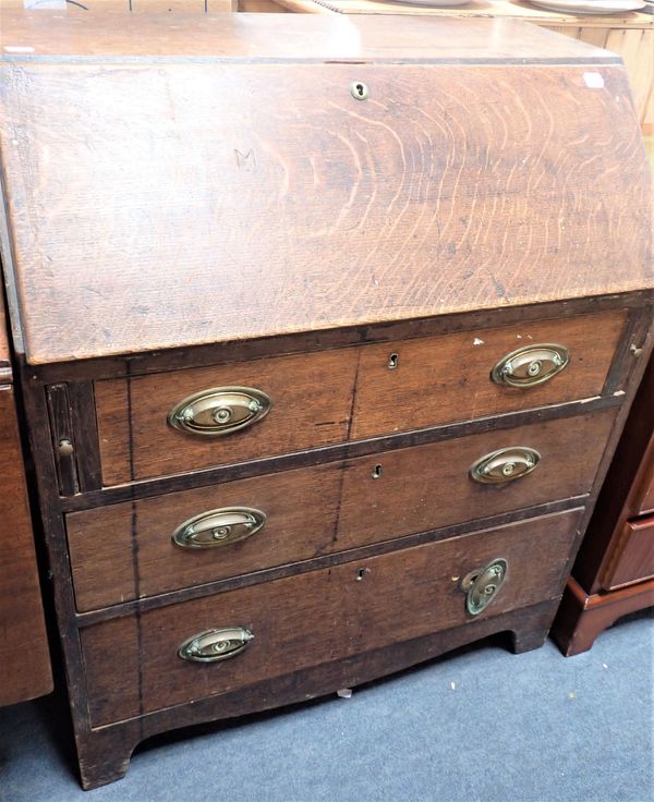 A GEORGE III OAK BUREAU OF SMALL PROPORTIONS