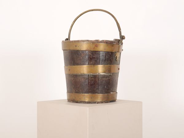A COOPERED OAK AND BRASS BOUND BUCKET