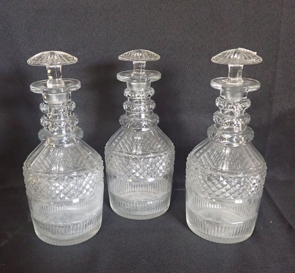 A SET OF THREE GEORGIAN CUT GLASS DECANTERS