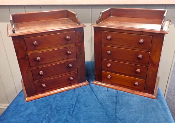 A PAIR OF VICTORIAN STYLE MAHOGANY MINIATURE CHESTS OF DRAWERS