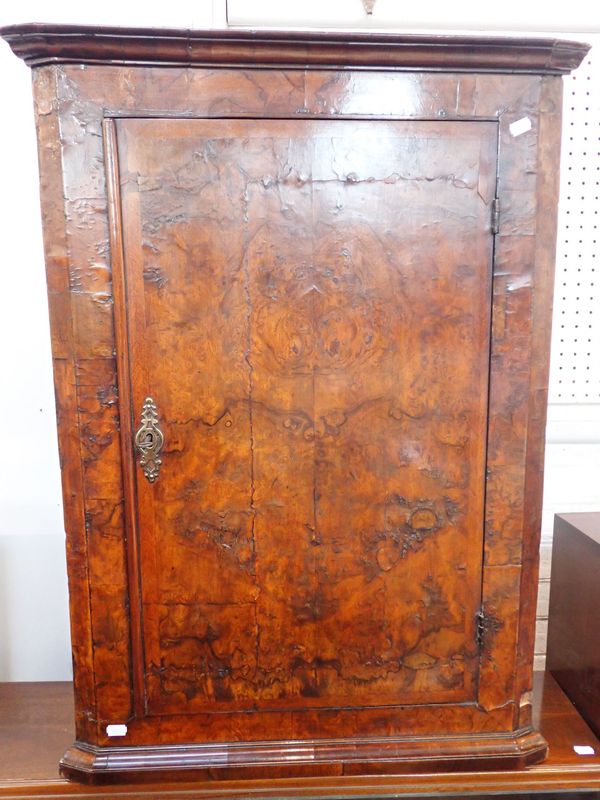 AN 18TH CENTURY FIGURED WALNUT HANGING CORNER CUPBOARD