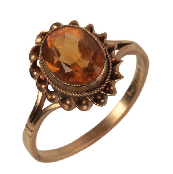 A 9CT GOLD BEZEL SET CITRINE RING