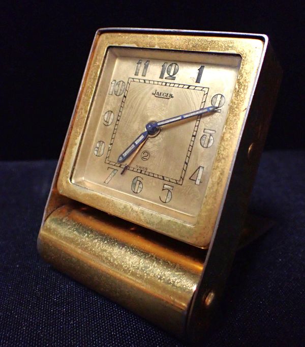 AN ART DECO STYLE JAEGER GILT METAL TRAVEL CLOCK