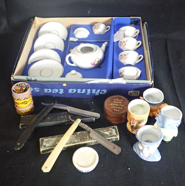 A CHILD'S TEASET (BOXED), FOUR NOVELTY EGG CUPS