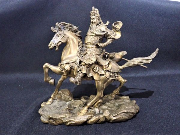 A CAST BRONZE FIGURE OF A CHINESE WARRIOR ON HORSEBACK