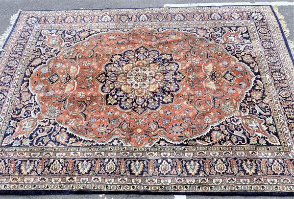 A LARGE BLUE GROUND KESHAN STYLE RUG