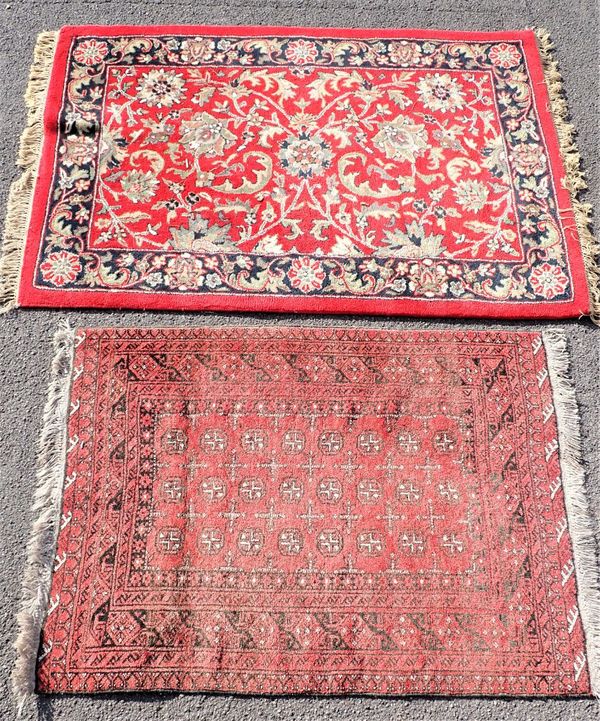 TWO RED GROUND RUGS