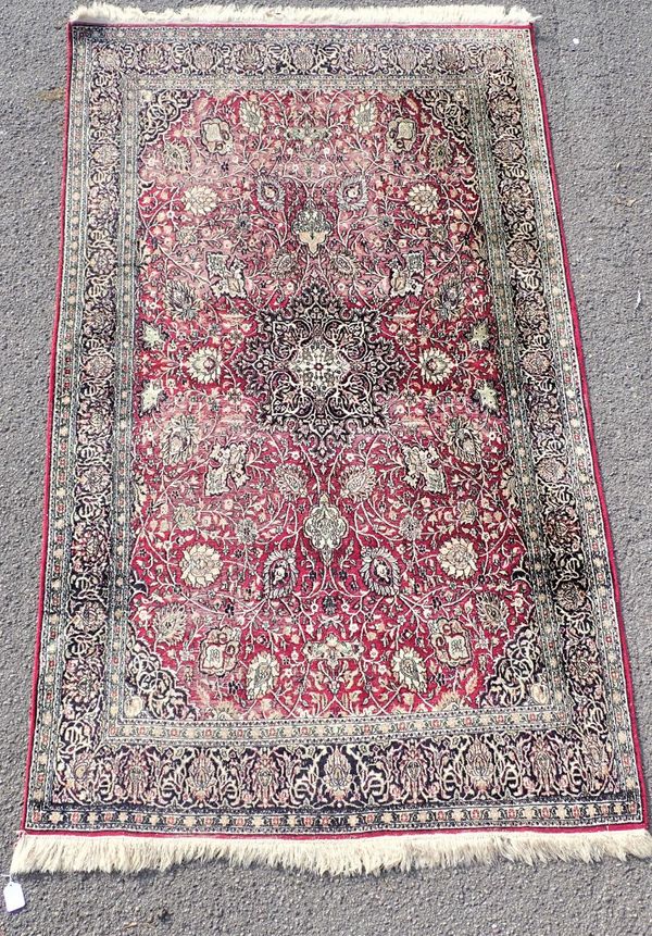 A PERSIAN RED GROUND SILK RUG