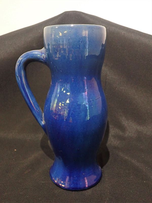 A BLUE IRIDESCENT GLAZED POTTERY TALL EWER