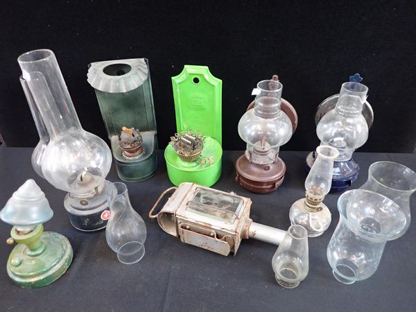 A COLLECTION OF TIN COTTAGE OIL LAMPS