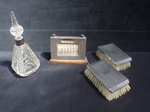 A SILVER FRONTED DESK CALENDAR