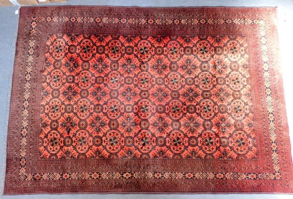 A LARGE RED GROUND BELUCH RUG