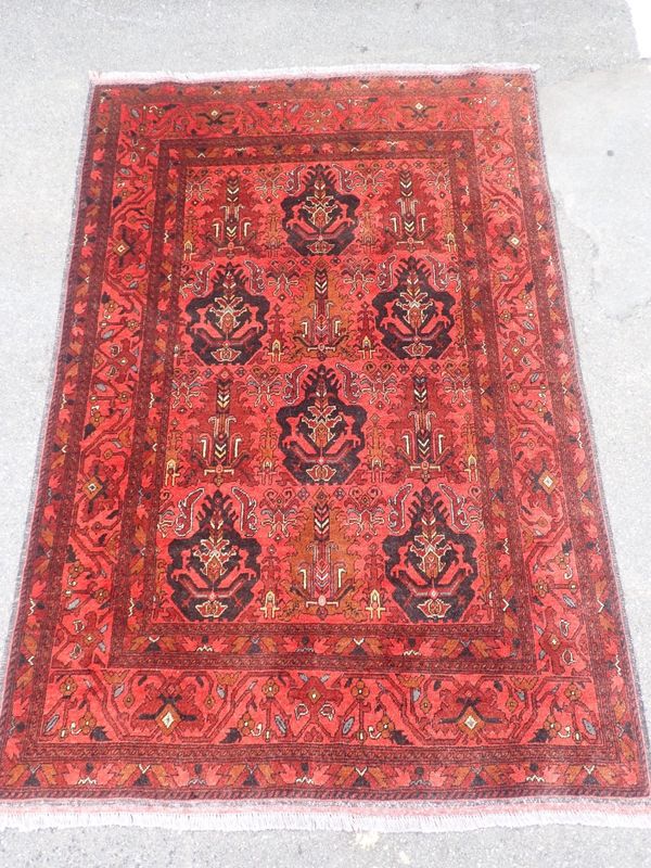 A RED GROUND BELOUCH RUG