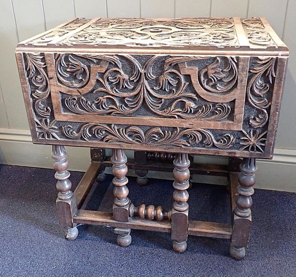 A SMALL WALNUT GATELEG TABLE, WITH PROFUSELY CARVED TOP