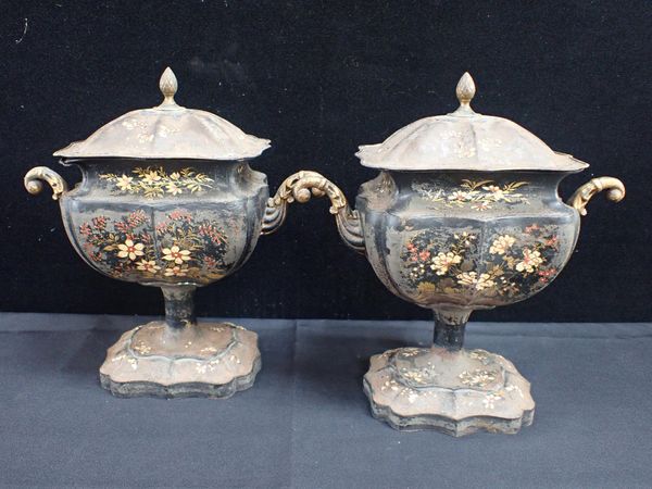 A PAIR OF 19th CENTURY PONTYPOOL TYPE TOLEWARE URNS AND COVERS