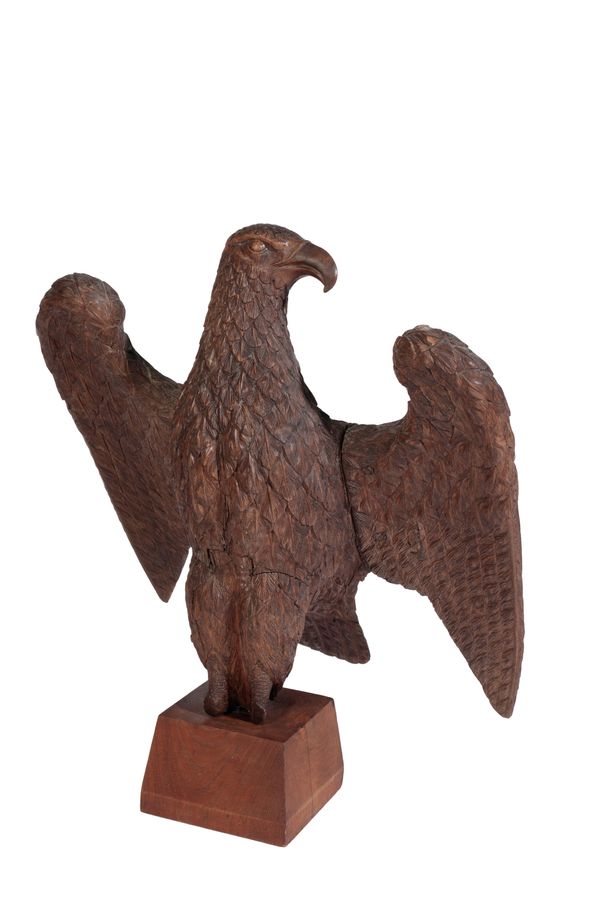 A CARVED WALNUT MODEL OF AN EAGLE,