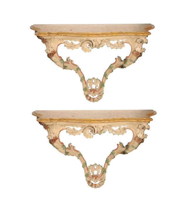 A PAIR OF ITALIAN CARVED AND PAINTED SOFTWOOD AND MARBLE MOUNTED CONSOLE TABLES,