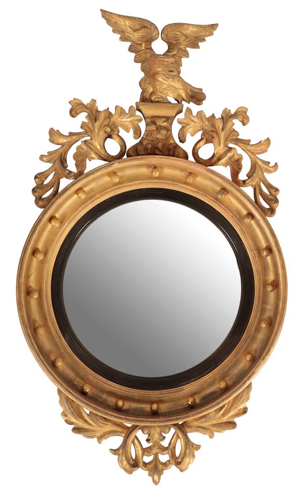 A REGENCY CARVED AND GILTWOOD FRAMED CONVEX WALL MIRROR,