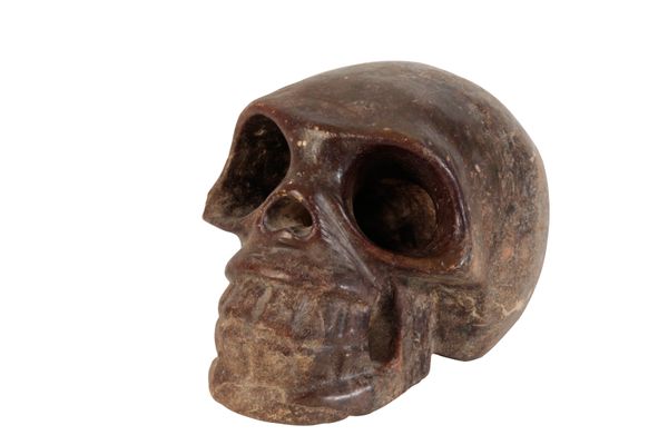 A CARVED MARBLE MODEL OF A HUMAN SKULL
