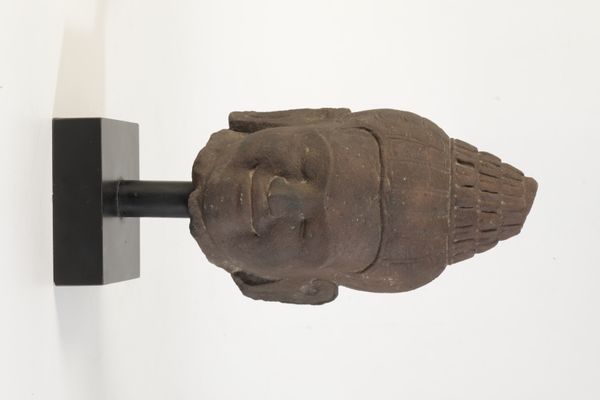 A SCULPTED LIMESTONE BUDDHISTIC HEAD