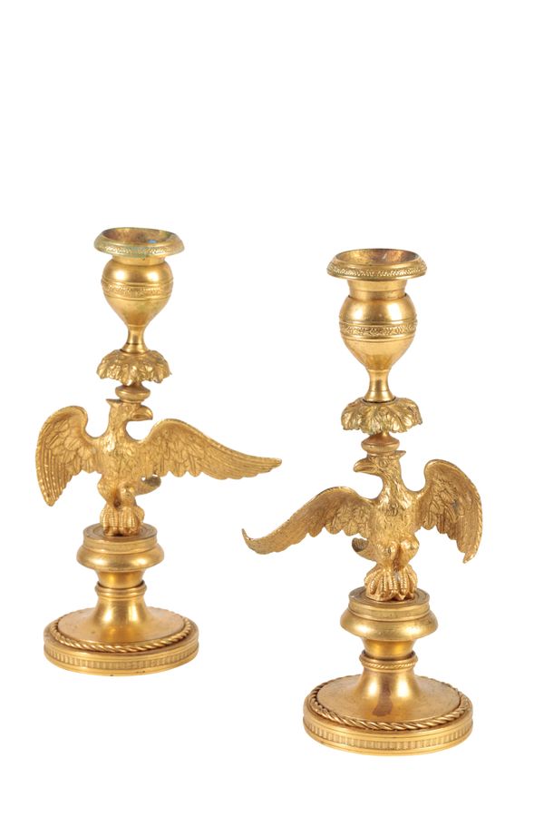 PAIR OF ORMOLU CANDLESTICKS CAST WITH SPREADEAGLES, EMPIRE OR POSSIBLY RUSSIAN