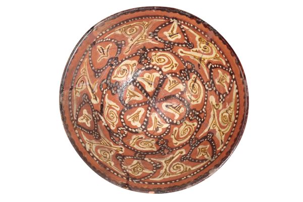 AN ISLAMIC BROWN-GLAZED POTTERY BOWL, POSSIBLY 12TH CENTURY