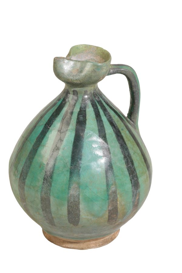 A PERSIAN GREEN-GLAZED POTTERY EWER, possibly 12th Century