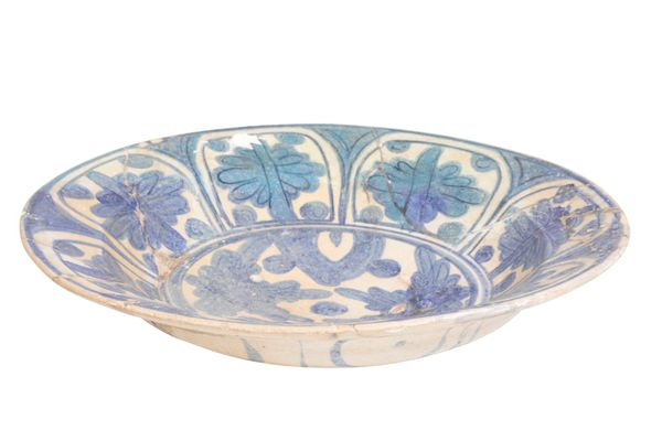 AN ISLAMIC BLUE AND WHITE GLAZED POTTERY DISH, possibly 16th Century