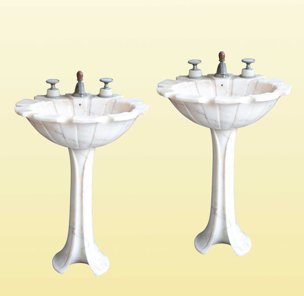 SHERLE WAGNER INTERNATIONAL: A PAIR OF ROSE AURORA MARBLE 'TULIP' PEDESTAL SINKS