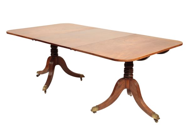 A REGENCY MAHOGANY TWIN PILLAR DINING TABLE,