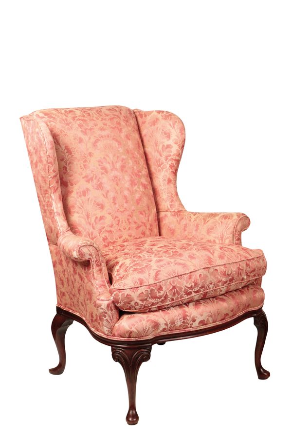 A CARVED MAHOGANY AND PINK DAMASK UPHOLSTERED WING ARMCHAIR IN GEORGE II STYLE,