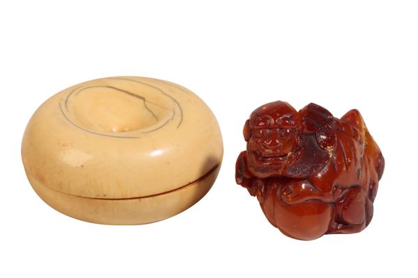 A CHINESE AMBER BUDDHISTIC LION, QING,