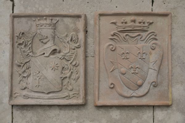 A PAIR OF ITALIAN TERACOTTA ARMORIAL PLAQUES