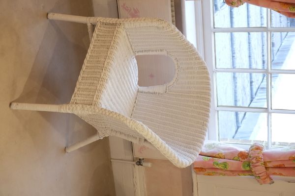A WHITE PAINTED WICKER CHAIR