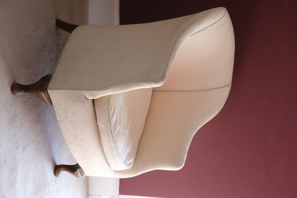 AN UPHOLSTERED TUB ARMCHAIR