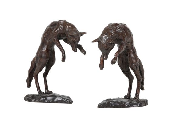 A PAIR OF PATINATED BRONZE MODELS OF FOXES, POSSIBLY BOOKENDS,