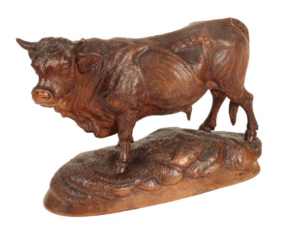 A 'BLACK FOREST' CARVED LINDEN WOOD MODEL OF A BULL,