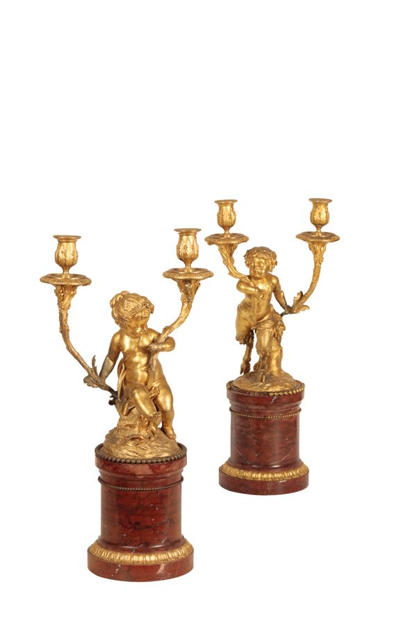 A PAIR OF GILT METAL AND MARBLE MOUNTED FIGURAL TWIN LIGHT CANDELABRA,