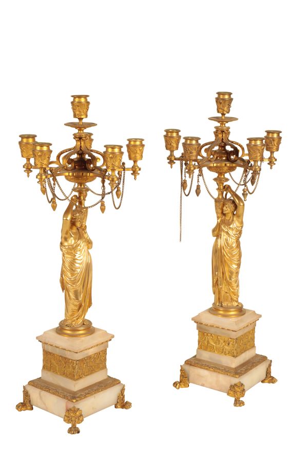 A PAIR OF FRENCH GILT BRONZE AND ONYX MOUNTED SIX LIGHT FIGURAL CANDELABRA,