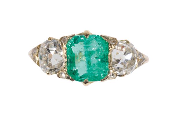 A THREE STONE EMERALD AND DIAMOND RING