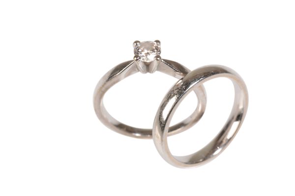 A DIAMOND SOLITAIRE RING AND WEDDING BAND,