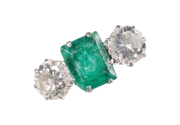 AN EMERALD AND DIAMOND THREE STONE RING