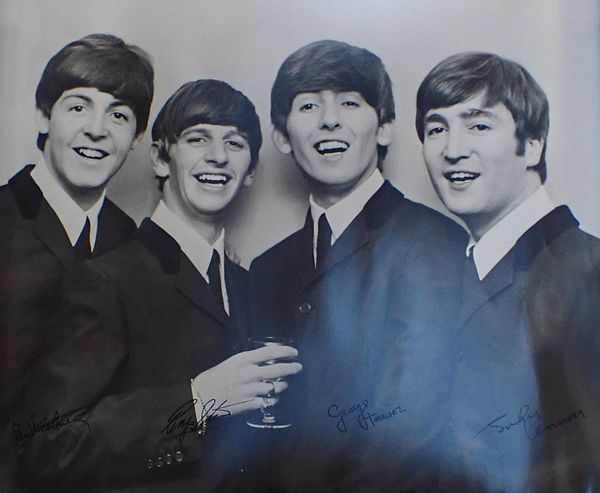 A BEATLES POSTER WITH STAMPED SIGNATURES