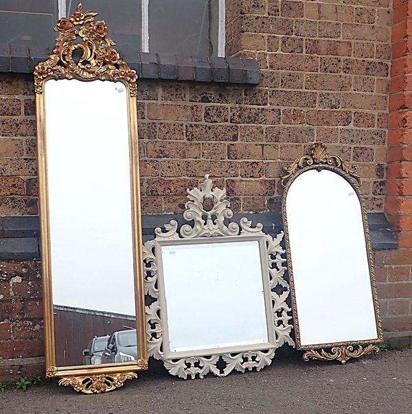 A GILT LONG WALL MIRROR, IN ROCOCO TASTE
