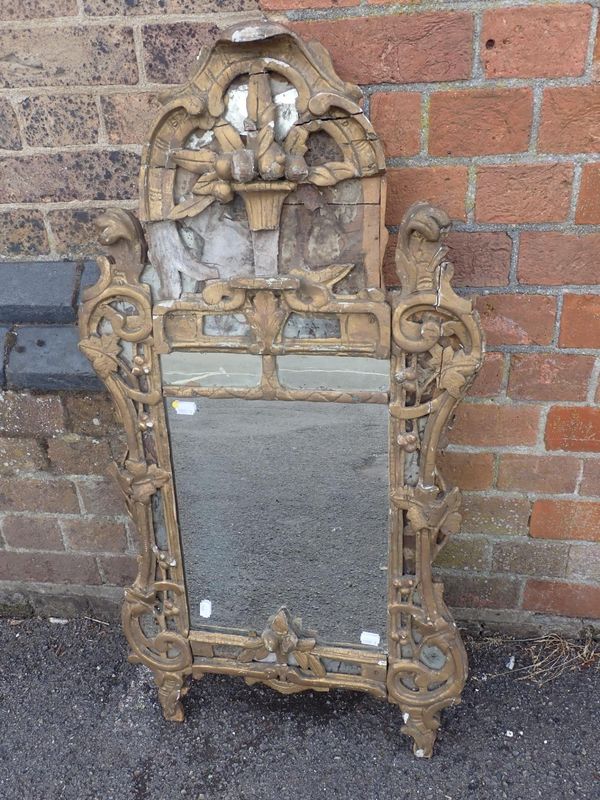 A CARVED GILTWOOD MIRROR, IN THE ROCOCO TASTE